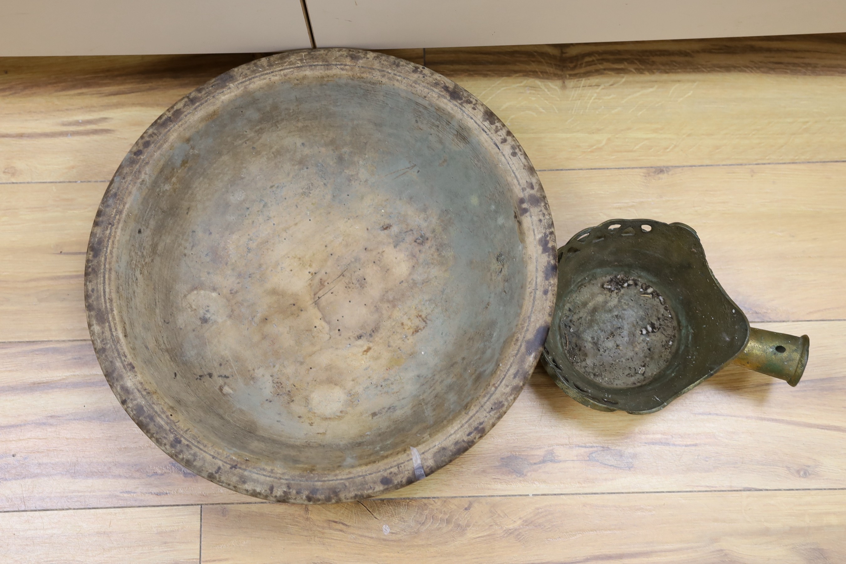 A 19th century Sycamore maizer bowl and a Chinese cast metal silk iron, diameter of bowl 42cm